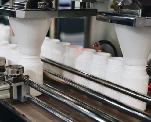 Supplements packaged in containers inside manufacturing facility