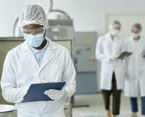 Worker in manufacturing facility with clipboard